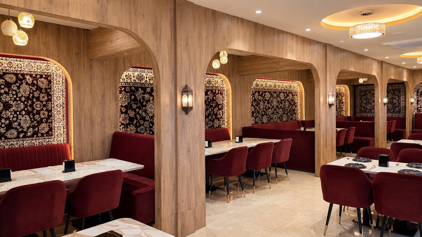 TEHZEEB luxury rooftop restaurant — warm maroon lighting, bar counter at night